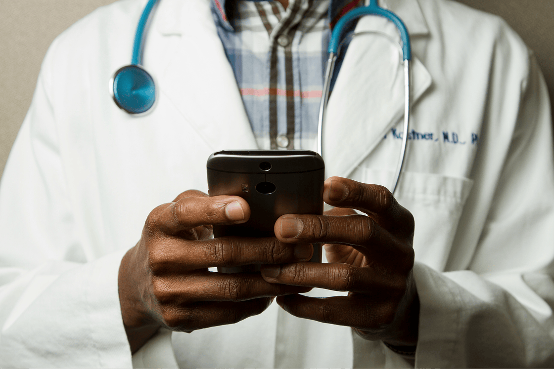 Doctor with smartphone in his hands.